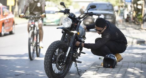 pessoa demonstrando cuidados essenciais com a moto